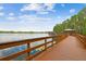 Wooden walkway leading to lakeside gazebo offers scenic views of water and trees at 21215 Preservation Dr, Land O Lakes, FL 34639