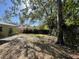 Expansive backyard offering ample space for outdoor activities, surrounded by mature trees and a wood fence at 2221 York S St, Gulfport, FL 33707