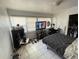 Bedroom featuring tile flooring, TV, closet, and natural light at 2221 York S St, Gulfport, FL 33707