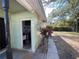View of home exterior with utility access and mature landscaping near the rear of the property at 2221 York S St, Gulfport, FL 33707