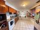 Cozy kitchen with light tile floor, wood cabinets, and serving bar at 2221 York S St, Gulfport, FL 33707