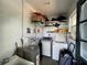 Functional laundry room with washer, dryer, sink, shelving, and a hot water heater at 2221 York S St, Gulfport, FL 33707
