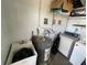 Well-equipped laundry area including washer, dryer, utility sink, shelving, and water heater at 2221 York S St, Gulfport, FL 33707