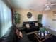 Spacious living room features dark furniture, ceiling fan, and decor plants at 2221 York S St, Gulfport, FL 33707