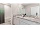 Bathroom with double sinks, granite counters and tiled shower-bath combo at 2257 Sienna Spruce St, Wesley Chapel, FL 33543