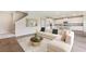 Open concept living room with large sectional, modern decor and easy access to the kitchen at 2257 Sienna Spruce St, Wesley Chapel, FL 33543