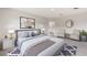 Tranquil main bedroom with a plush bed, modern decor, and ensuite bathroom entrance at 2257 Sienna Spruce St, Wesley Chapel, FL 33543