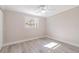 Bright bedroom featuring a ceiling fan, light gray walls, and light wood-look flooring at 2285 Victory Ave, Largo, FL 33770