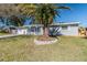 Charming single-story home with a well-maintained lawn and a mature palm tree in the front yard at 2285 Victory Ave, Largo, FL 33770