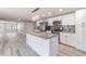Bright, remodeled kitchen featuring an island, stainless appliances, modern countertops, and light wood flooring at 2285 Victory Ave, Largo, FL 33770