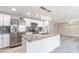 Modern kitchen featuring white cabinets, stainless steel appliances, gray countertops and stylish backsplash at 2285 Victory Ave, Largo, FL 33770