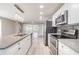 Modern kitchen features stainless appliances, quartz countertops, and white cabinetry at 2285 Victory Ave, Largo, FL 33770