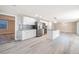 Open-concept kitchen with island, stainless steel appliances, white cabinets, and adjacent living space at 2285 Victory Ave, Largo, FL 33770