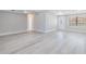 Spacious living room featuring modern flooring, neutral paint, large windows, and plenty of natural light at 2285 Victory Ave, Largo, FL 33770