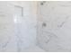 Close-up of a modern shower with marble tiling and a recessed shelf at 2285 Victory Ave, Largo, FL 33770