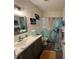 Cozy bathroom featuring a vanity with sink, toilet, and shower with decorative marble-look curtain at 2434 Australia E Way # 50, Clearwater, FL 33763