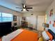 Bright bedroom featuring a fan, hardwood floors, dining table, and sliding-door closet at 2434 Australia E Way # 50, Clearwater, FL 33763