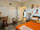Bedroom featuring a fan, hardwood floors, table with chairs, and sliding-door closet at 2434 Australia E Way # 50, Clearwater, FL 33763