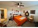 Bright bedroom featuring hardwood floors, stylish decor, bedside table, and fan at 2434 Australia E Way # 50, Clearwater, FL 33763