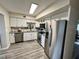 Modern kitchen features stainless steel appliances, granite countertops, and white cabinets at 2434 Australia E Way # 50, Clearwater, FL 33763