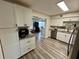 Bright kitchen features stainless steel appliances, granite counters, and a view into the living room at 2434 Australia E Way # 50, Clearwater, FL 33763