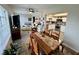 Open-concept living and dining area with a view of the modern kitchen, plus hardwood floors throughout at 2434 Australia E Way # 50, Clearwater, FL 33763