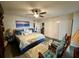 Spacious main bedroom with a king-size bed, ceiling fan, and comfortable seating at 2434 Australia E Way # 50, Clearwater, FL 33763
