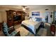 Relaxing main bedroom with a king bed, rocking chairs, and custom entertainment center at 2434 Australia E Way # 50, Clearwater, FL 33763