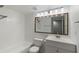 Bright bathroom with white vanity, a large mirror, and a shower/tub combo at 2500 Winding Creek Blvd # A104, Clearwater, FL 33761