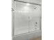 Clean bathroom featuring a tub with white tiling and clear glass shower door at 2500 Winding Creek Blvd # A104, Clearwater, FL 33761