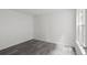 A sunlit bedroom showcasing sleek gray wood floors and fresh, white walls at 2500 Winding Creek Blvd # A104, Clearwater, FL 33761