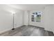 Bright bedroom featuring gray wood-look flooring and a large window with tree views at 2500 Winding Creek Blvd # A104, Clearwater, FL 33761
