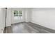 Spacious bedroom features gray wood-look flooring and large bright window at 2500 Winding Creek Blvd # A104, Clearwater, FL 33761