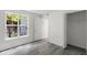 Bright bedroom featuring hard surface floors, a window, and a closet at 2500 Winding Creek Blvd # A104, Clearwater, FL 33761
