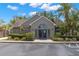 Beautiful community clubhouse with gray siding, well-maintained landscaping, and manicured bushes at 2500 Winding Creek Blvd # A104, Clearwater, FL 33761