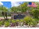 A beautiful community entrance with lush landscaping and an American flag at 2500 Winding Creek Blvd # A104, Clearwater, FL 33761