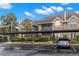 Attractive condo building with reserved parking, brick accents and mature trees at 2500 Winding Creek Blvd # A104, Clearwater, FL 33761