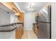 Well-equipped kitchen with stainless steel appliances and tile flooring for easy maintenance at 2500 Winding Creek Blvd # A104, Clearwater, FL 33761