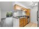 Well-lit kitchen features a breakfast bar, stainless steel appliances, and tile flooring at 2500 Winding Creek Blvd # A104, Clearwater, FL 33761