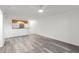 Open living space with gray wood-look flooring, ceiling fan, and natural light at 2500 Winding Creek Blvd # A104, Clearwater, FL 33761