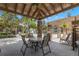 Picturesque outdoor gazebo seating area complete with table and chairs and pool in the distance at 2500 Winding Creek Blvd # A104, Clearwater, FL 33761