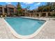 Clear community pool with lounge chairs in outdoor gazebo; surrounded by lush landscape at 2500 Winding Creek Blvd # A104, Clearwater, FL 33761