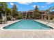 Relaxing pool surrounded by lounge chairs and umbrellas with an outdoor gazebo nearby at 2500 Winding Creek Blvd # A104, Clearwater, FL 33761