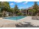 A refreshing pool sits in a brick-paved area, surrounded by sun loungers and umbrellas for relaxation at 2500 Winding Creek Blvd # A104, Clearwater, FL 33761