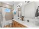 Modern bathroom featuring a double sink vanity with wood cabinets and rectangular mirrors at 3070 Smilodon Trl, Ruskin, FL 33570