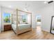 Bedroom suite featuring a king bed and ensuite bathroom at 3070 Smilodon Trl, Ruskin, FL 33570