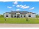 Beautiful exterior showcasing a modern farmhouse design with a well-manicured lawn at 3070 Smilodon Trl, Ruskin, FL 33570
