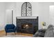 Modern fireplace with a stone surround and decorative mirror accent at 3070 Smilodon Trl, Ruskin, FL 33570