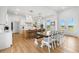 Bright, open kitchen with island seating, modern pendant lights, and a dining table at 3070 Smilodon Trl, Ruskin, FL 33570