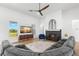 Bright living room with stylish decor, a stone fireplace, and large windows at 3070 Smilodon Trl, Ruskin, FL 33570